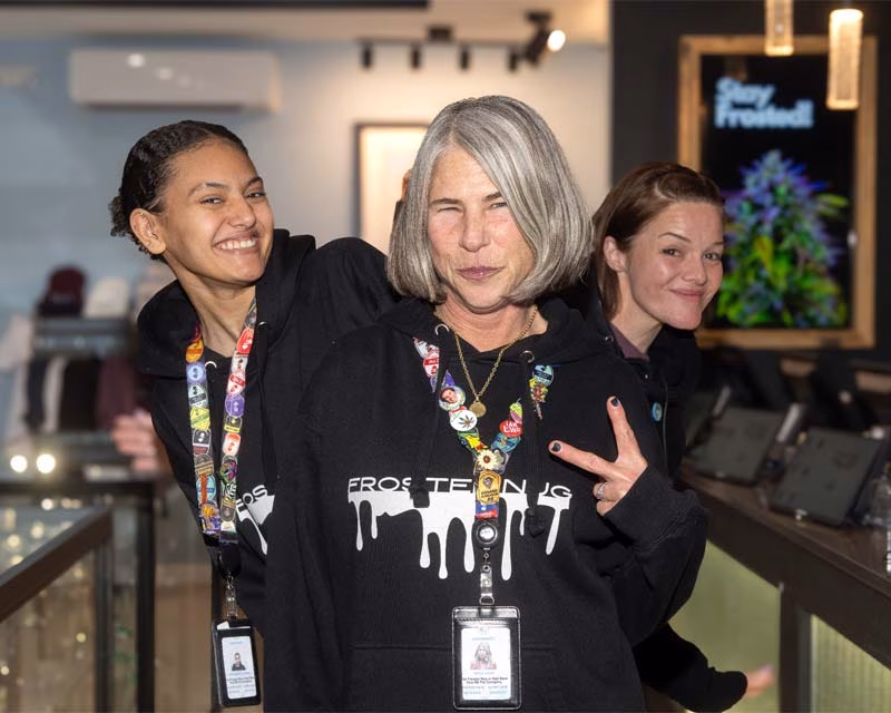 Frosted Nug New Jersey Dispensary Employees Posing for the Camera and Giving a Peace Sign.